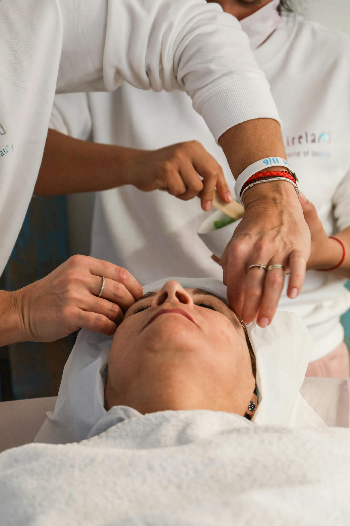 Woman receiving a soothing facial massage in a serene spa environment.